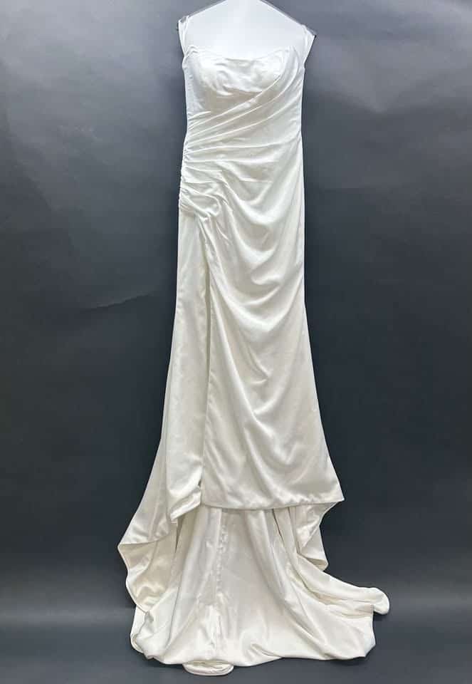 Cleaned white wedding gown hanging after professional gown care