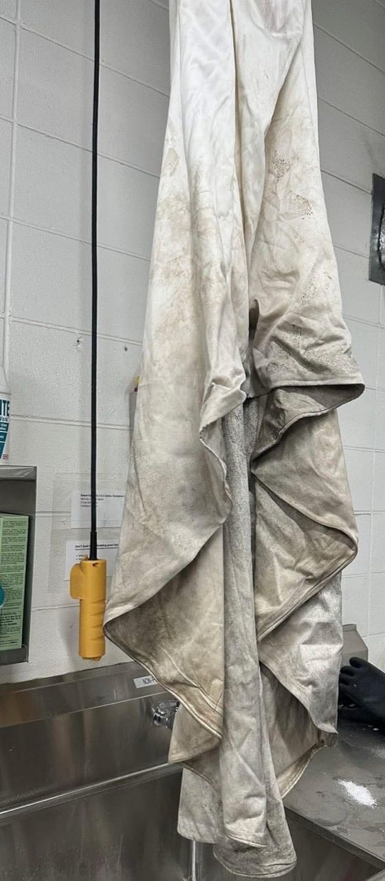 Wedding gown with visible hemline soil before professional cleaning and preservation review