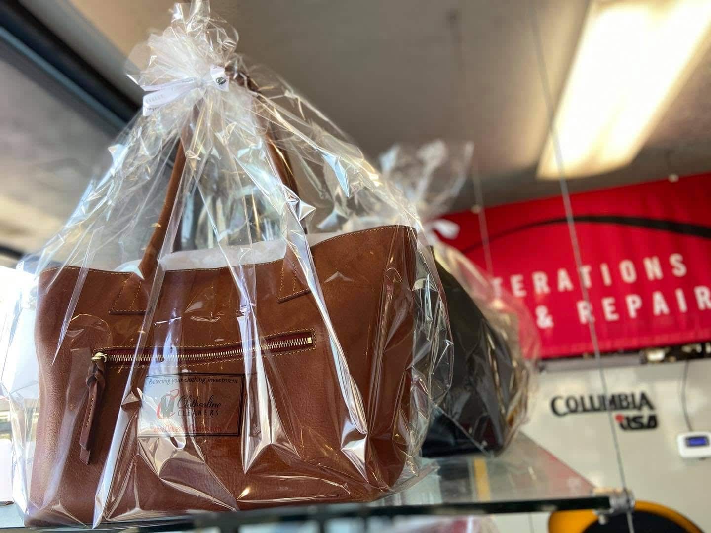 Leather handbag packaged after cleaning at Clothesline Cleaners